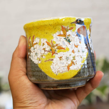 Kutani tea cup with Yoshidaya cherry blossoms and birds—premium Japanese ceramic ware.
