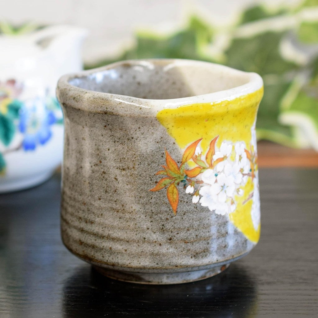 Kutani tea cup with Yoshidaya cherry blossoms and birds—premium Japanese ceramic ware.